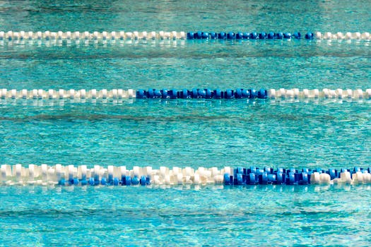 Vibrant swimming pool with blue and white lane dividers, ideal for competitions.